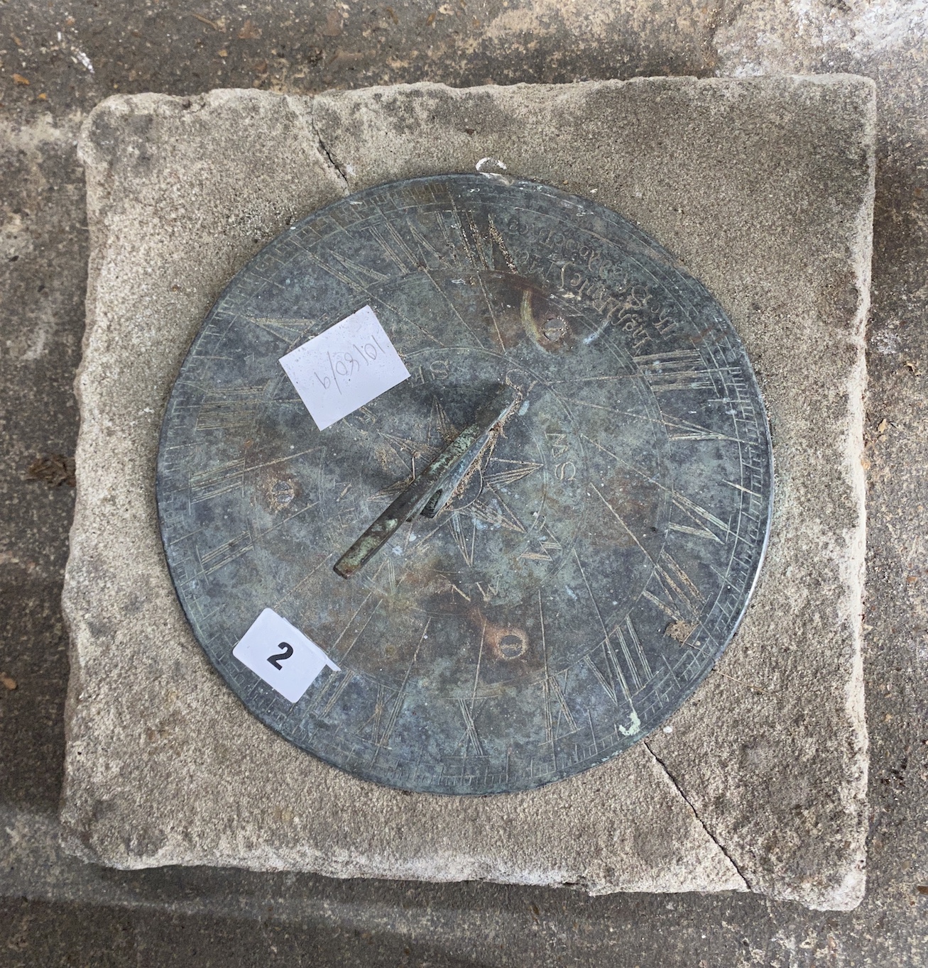 A circular metal and reconstituted stone sun dial, width 30cm